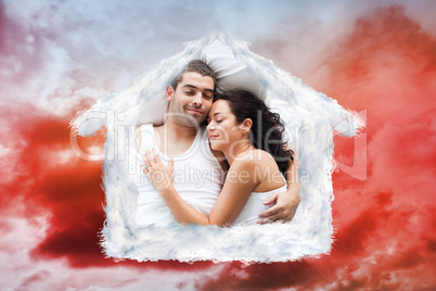 Composite image of beautiful couple lying on a bed