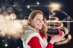 Composite image of surprised woman opening gift while looking at