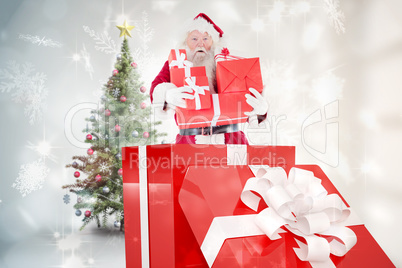 Composite image of santa standing in large gift