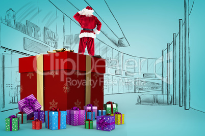 Composite image of santa standing on giant present