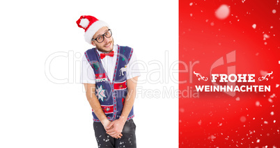 Composite image of geeky hipster in santa hat