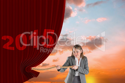 Composite image of businesswoman pulling a rope