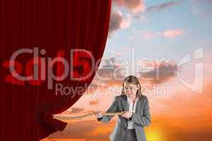 Composite image of businesswoman pulling a rope