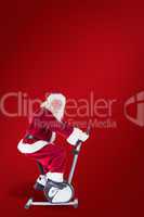 Composite image of santa uses a home trainer