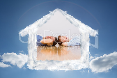 Composite image of couple lying on the floor