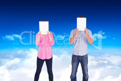 Composite image of people holding sheets over faces