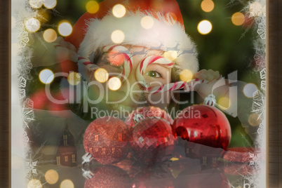 Composite image of festive little girl smiling at camera