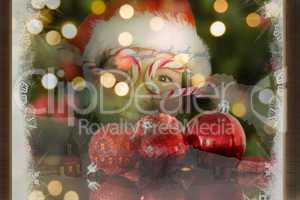 Composite image of festive little girl smiling at camera