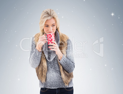 Woman in winter clothes holding a mug