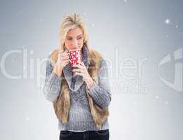 Woman in winter clothes holding a mug