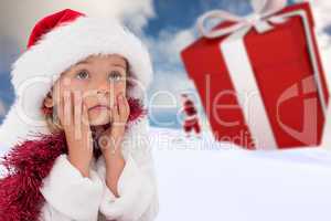 Composite image of cute little girl wearing santa hat and tinsel