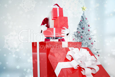 Composite image of santa standing in large gift