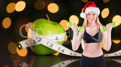 Composite image of festive fit blonde smiling at camera