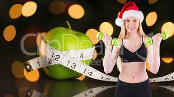 Composite image of festive fit blonde smiling at camera