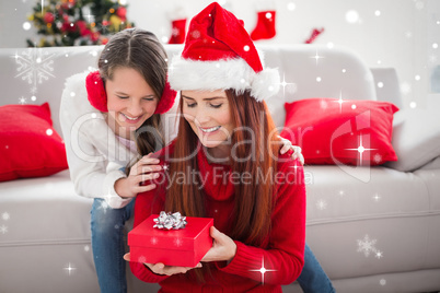 Composite image of festive mother and daughter with a christmas