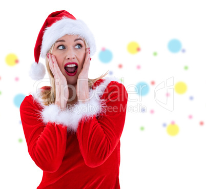 Composite image of festive blonde with hands on face