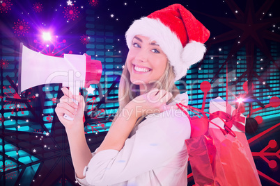 Composite image of festive blonde holding megaphone and bags