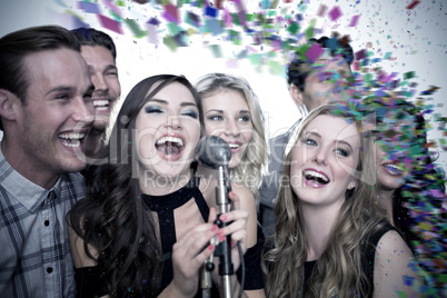 Composite image of friends singing karaoke