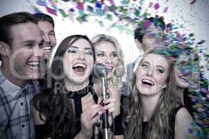 Composite image of friends singing karaoke
