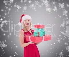 Composite image of pretty blonde hoding christmas gifts