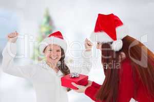 Composite image of mother and daughter with gift