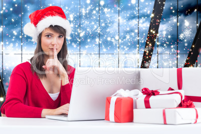 Composite image of festive brunette keeping a secret