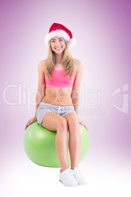 Festive fit blonde sitting on exercise ball