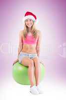 Festive fit blonde sitting on exercise ball