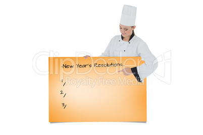 Composite image of female chef pointing on billboard