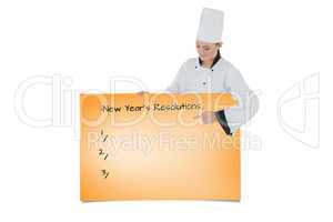 Composite image of female chef pointing on billboard