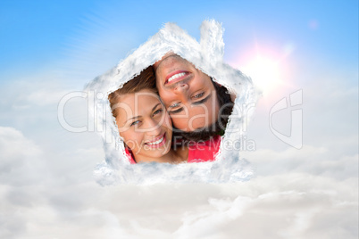 Composite image of close up of two friends looking upwards while