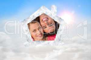 Composite image of close up of two friends looking upwards while