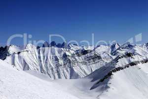 Off-piste slope in sun day and traces of avalanches, ski and sno