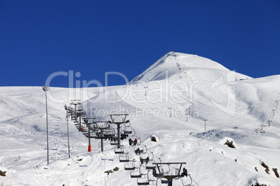 Winter mountains and ski slope at nice sun day