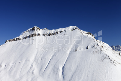 Snowy rocks in sun day