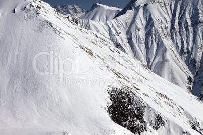 Snowy rocks with avalanches