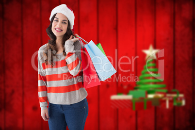 Composite image of beauty brunette posing with shopping bags