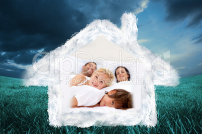 Composite image of family realxing in parents bed