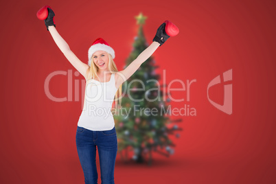 Composite image of festive blonde cheering with boxing gloves