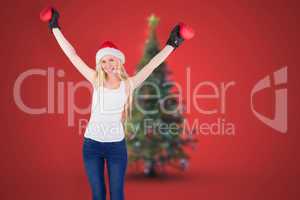 Composite image of festive blonde cheering with boxing gloves