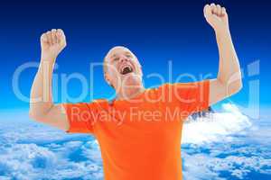 Composite image of mature man in orange tshirt cheering