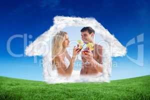 Composite image of happy young couple holding cocktails