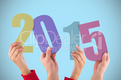 Composite image of hands holding poster