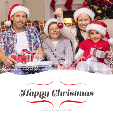 Composite image of happy family wearing santa hat on the couch