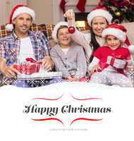 Composite image of happy family wearing santa hat on the couch