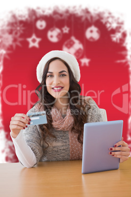 Composite image of woman with tablet and credit card