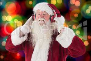 Composite image of santa claus enjoys some music