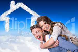 Composite image of smiling young man carrying woman