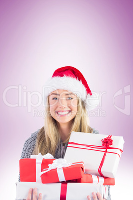 Festive blonde holding pile of gifts