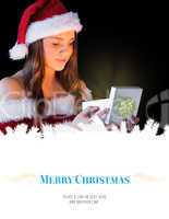 Composite image of pretty brunette in santa outfit opening gift